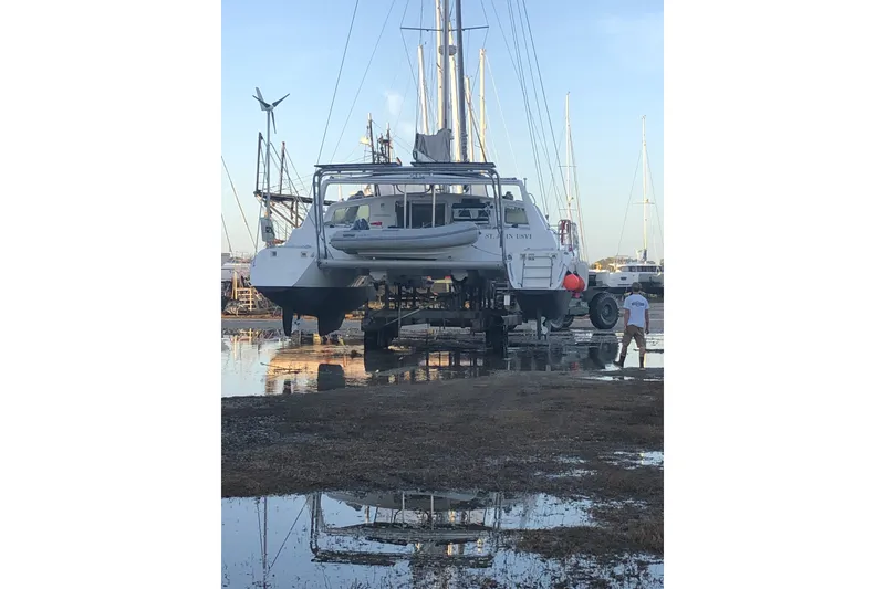 Slide: The Image of Catamaran Voyage 440, 2002 model, on dry dock with reflections in water. - 36