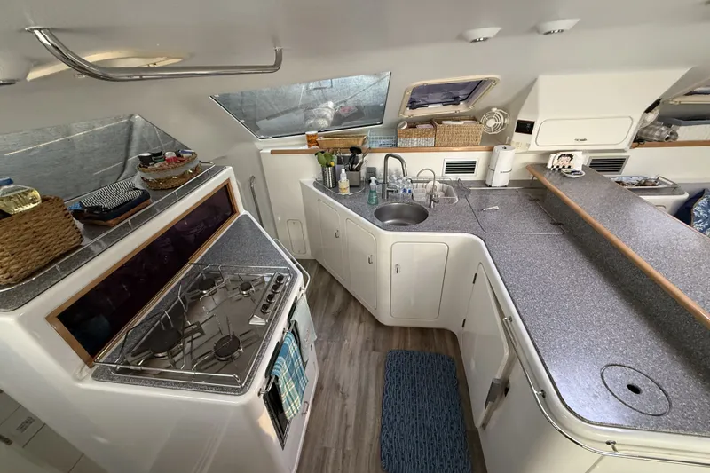 Slide: The Image of Interior of a 2002 Voyage 440 yacht kitchen with modern amenities and sleek design. - 14