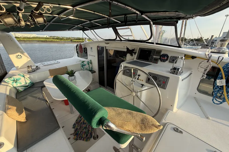 Slide: The Image of Luxurious 2002 Voyage 440 yacht cockpit with steering wheel, seating, and navigation equipment. - 2