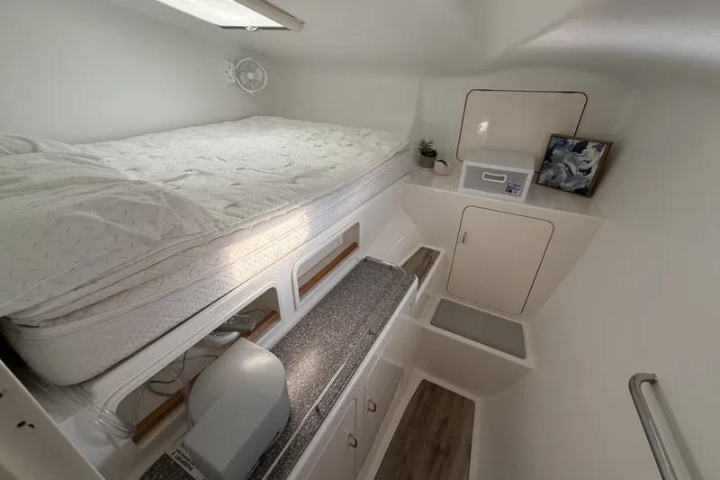 Slide: The Image of Cozy cabin interior of 2002 Voyage 440 yacht with bed, storage, and decor. - 20