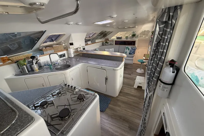 Slide: The Image of Spacious 2002 Voyage 440 yacht interior with modern kitchen and cozy seating area. - 12