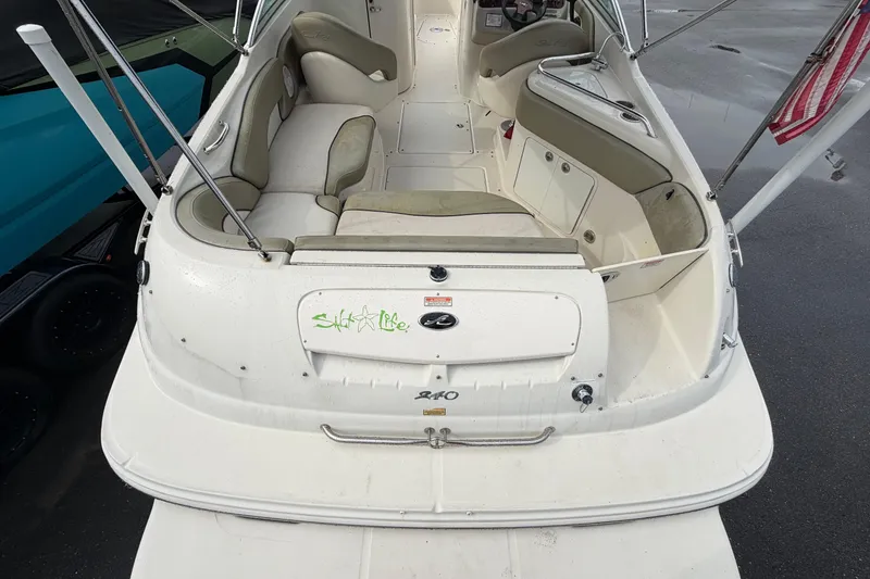 Slide: The Image of 2005 Sea Ray 240 Sundeck boat interior with seating and storage compartments. - 12