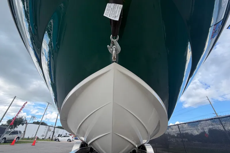 Slide: The Image of The 2005 Sea Ray 240 Sundeck features a green hull and is positioned on a trailer. - 11