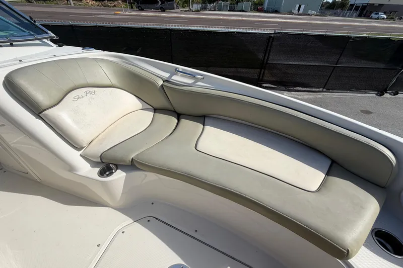 Slide: The Image of 2005 Sea Ray 240 Sundeck boat interior with cushioned seating area. - 54