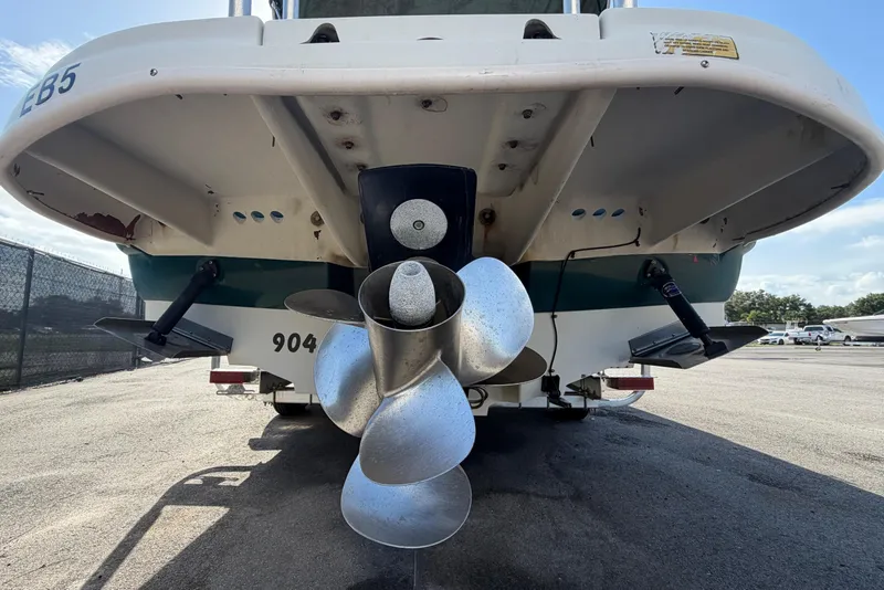 Slide: The Image of The image shows the stern of a 2005 Sea Ray 240 Sundeck with a large propeller. - 3