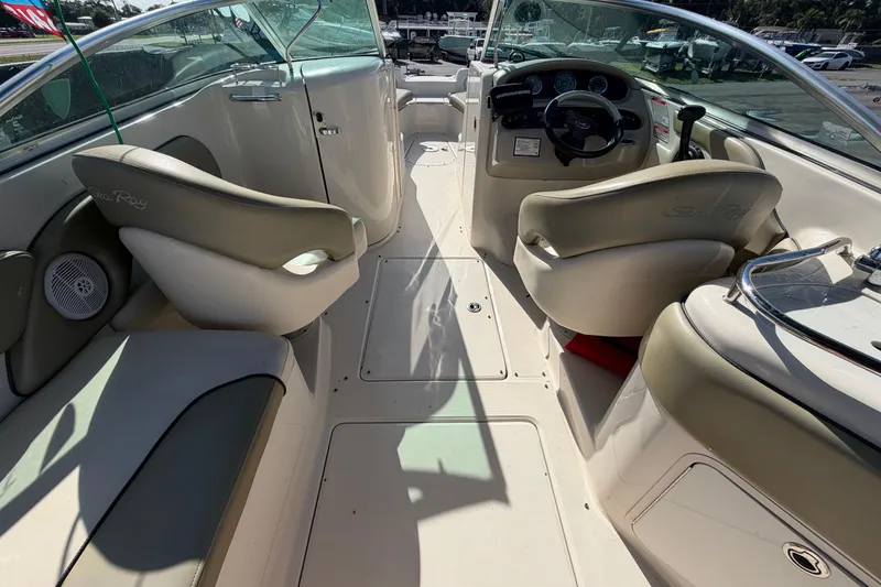 Slide: The Image of 2005 Sea Ray 240 Sundeck interior with helm, seating, and dashboard. - 21