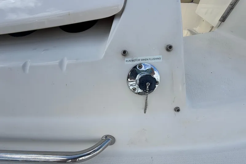 Slide: The Image of 2005 Sea Ray 240 Sundeck motor flushing port with safety instructions. - 78