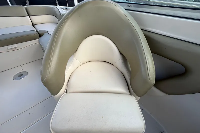 Slide: The Image of 2005 Sea Ray 240 Sundeck interior seating with beige and white upholstery. - 60