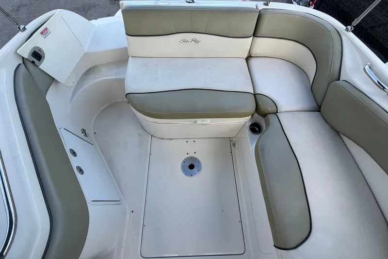 Slide: The Image of 2005 Sea Ray 240 Sundeck interior with cushioned seating and cup holder. - 63