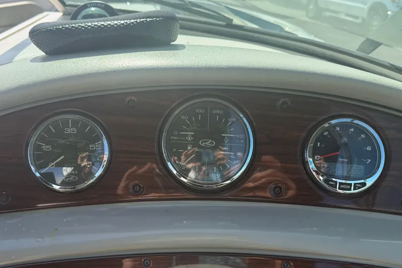 Slide: The Image of Dashboard of a 2005 Sea Ray 240 Sundeck boat with gauges and reflections. - 26