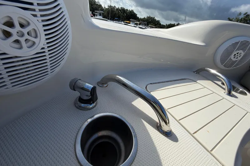 Slide: The Image of 2005 Sea Ray 240 Sundeck boat deck with speakers and stainless steel fixtures. - 51