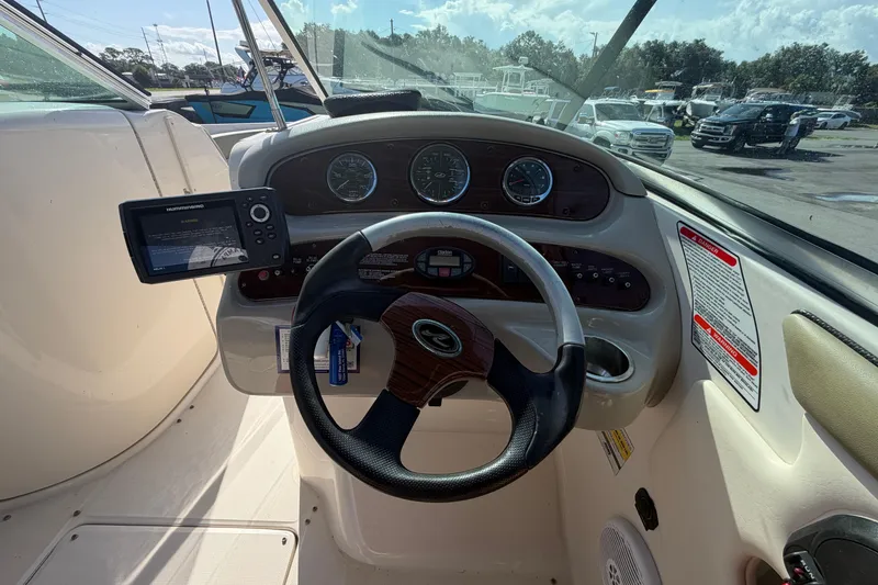 Slide: The Image of Steering console of a 2005 Sea Ray 240 Sundeck with gauges and navigation system. - 24