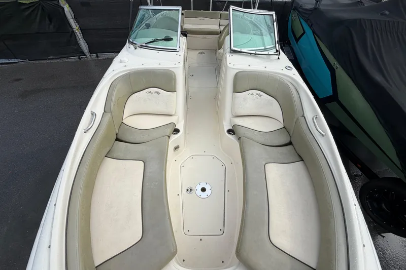 Slide: The Image of 2005 Sea Ray 240 Sundeck boat interior with spacious seating and open deck layout. - 19