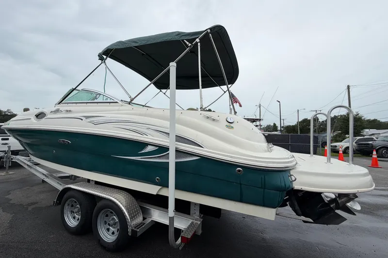 Slide: The Image of 2005 Sea Ray 240 Sundeck boat on trailer with canopy, parked outdoors. - 6
