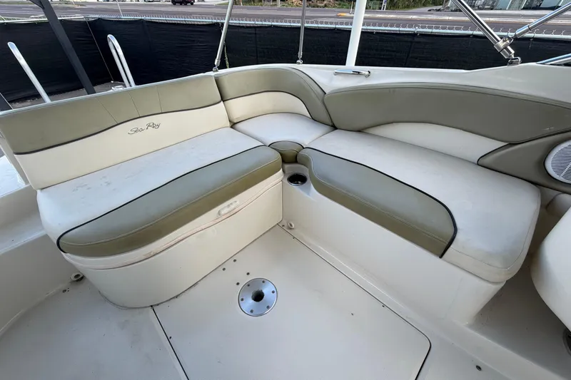 Slide: The Image of 2005 Sea Ray 240 Sundeck interior seating with beige and white upholstery. - 64