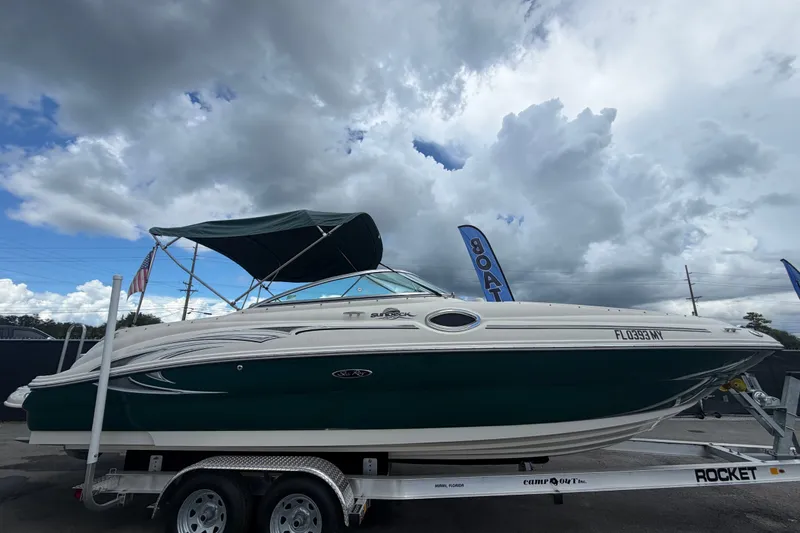 Slide: The Image of 2005 Sea Ray 240 Sundeck boat on trailer under cloudy sky. - 1