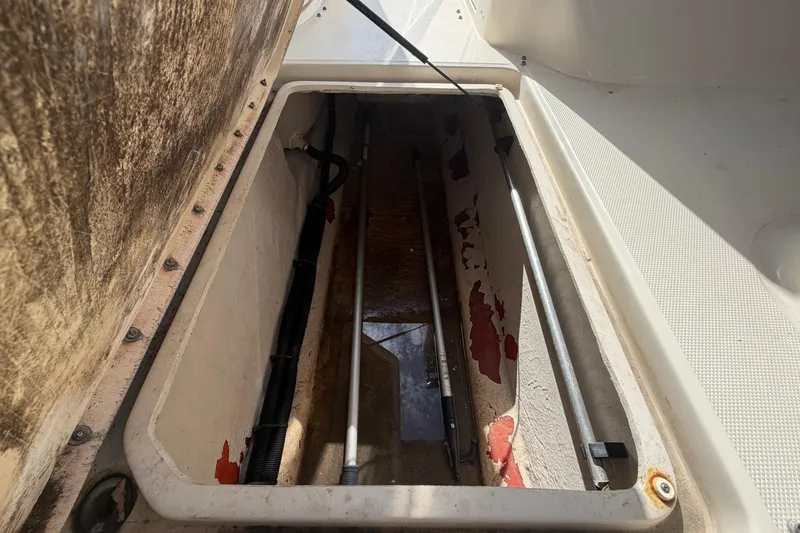 Slide: The Image of Storage compartment of a 2005 Sea Ray 240 Sundeck boat, showing interior details. - 34