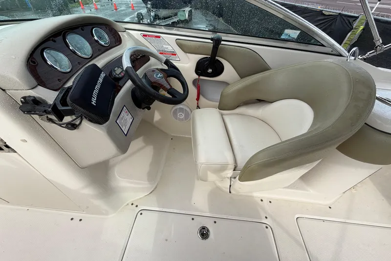 Slide: The Image of 2005 Sea Ray 240 Sundeck cockpit with steering wheel and control panel. - 15