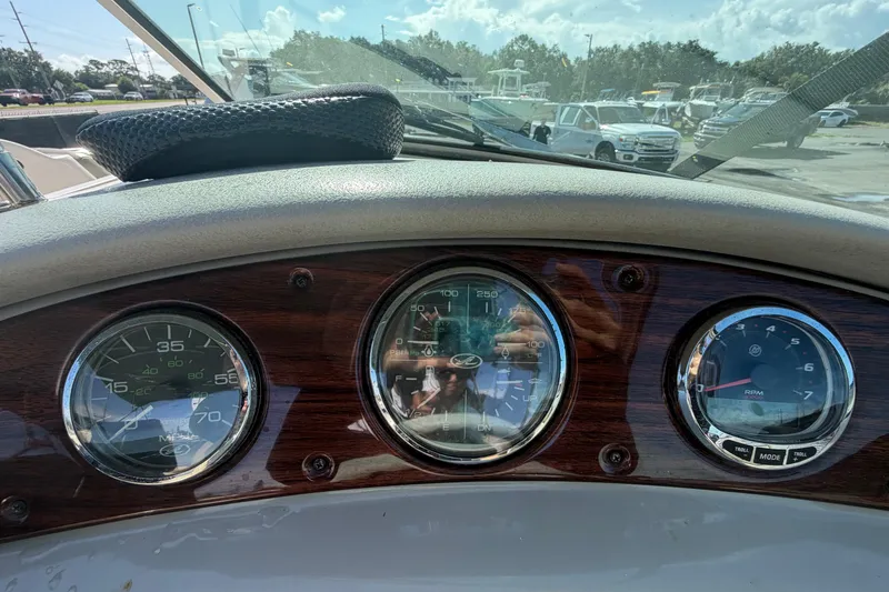 Slide: The Image of Dashboard of a 2005 Sea Ray 240 Sundeck boat with gauges and controls. - 25