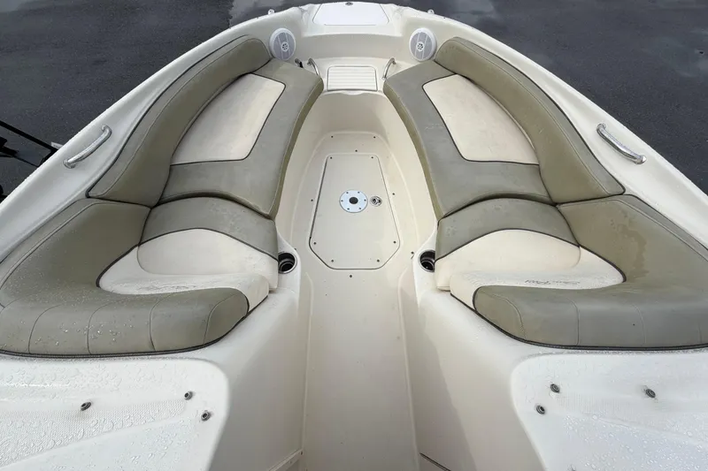 Slide: The Image of 2005 Sea Ray 240 Sundeck boat interior with cushioned seating and wet surfaces. - 17
