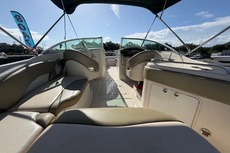Slide: The Image of 2005 Sea Ray 240 Sundeck interior with seating and helm under canopy. - 15