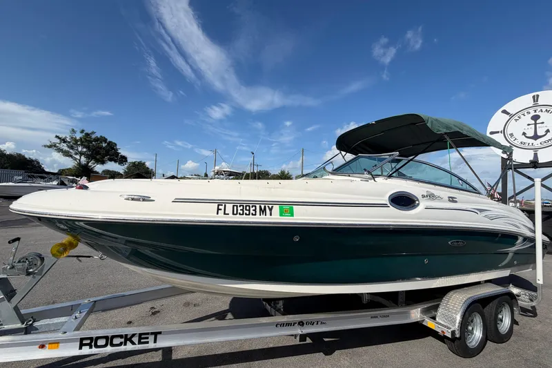 Slide: The Image of 2005 Sea Ray 240 Sundeck boat on trailer under clear blue sky. - 9