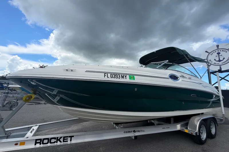 Slide: The Image of 2005 Sea Ray 240 Sundeck boat on trailer under cloudy sky. - 9