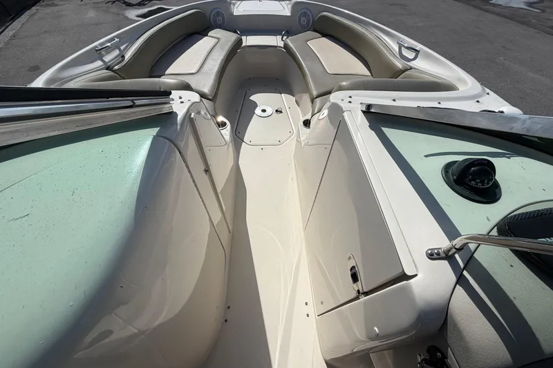 Slide: The Image of 2005 Sea Ray 240 Sundeck interior with seating and navigation equipment. - 41