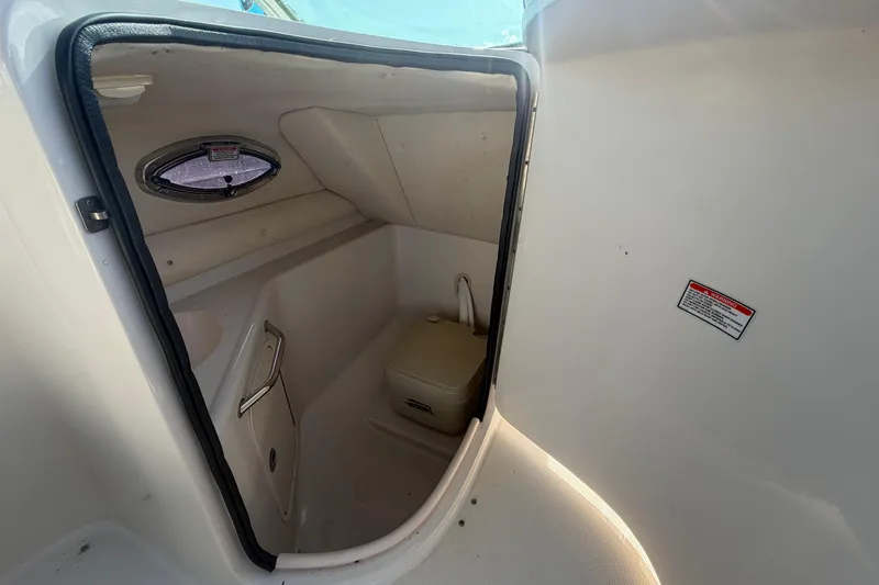 Slide: The Image of Interior of 2005 Sea Ray 240 Sundeck boat showing compact restroom area. - 37