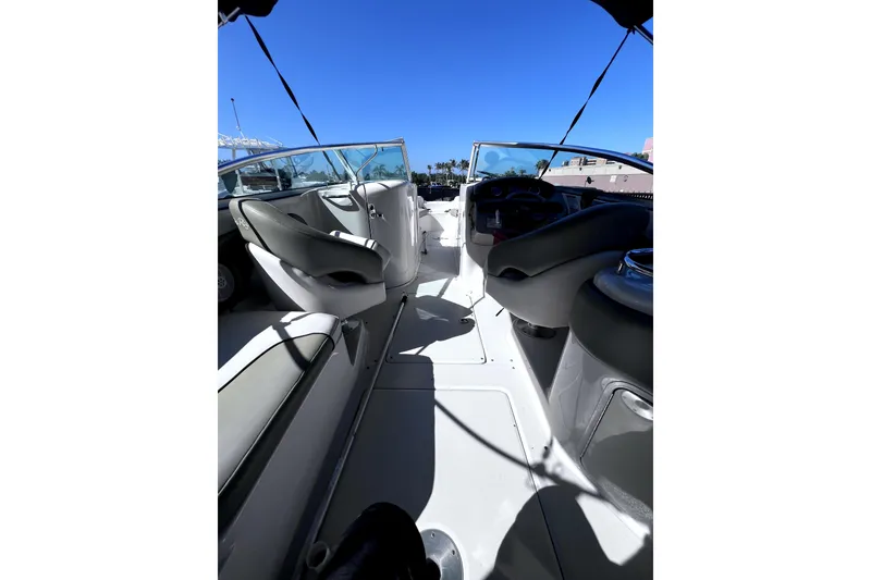 Slide: The Image of Interior view of a 2005 Sea Ray 240 Sundeck boat under clear blue skies. - 4