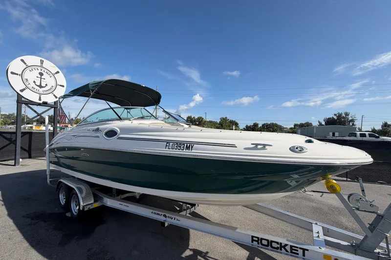 The Image of 2005 Sea Ray 240 Sundeck boat on trailer under clear blue sky. - 0