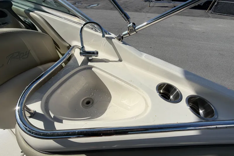 Slide: The Image of 2005 Sea Ray 240 Sundeck boat sink with faucet and cup holders. - 17