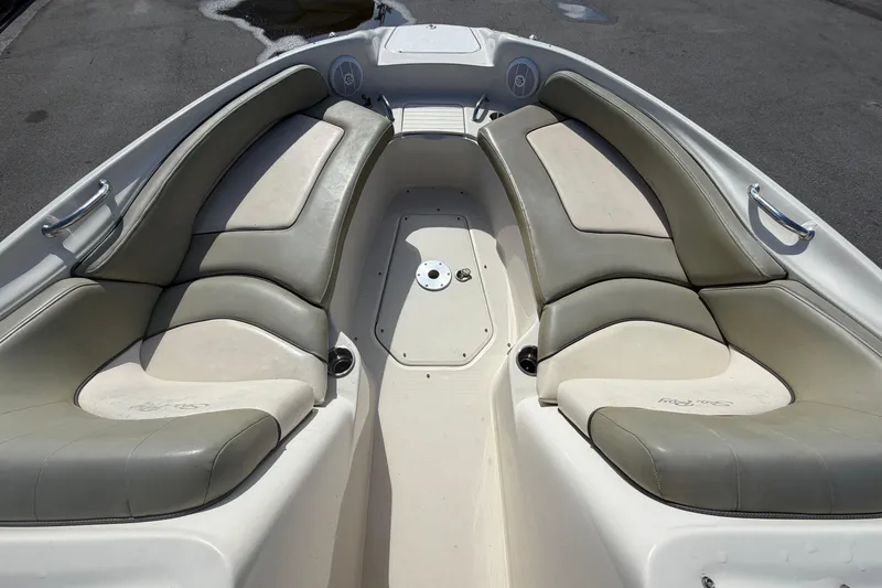 Slide: The Image of 2005 Sea Ray 240 Sundeck boat interior with cushioned seating and sleek design. - 45