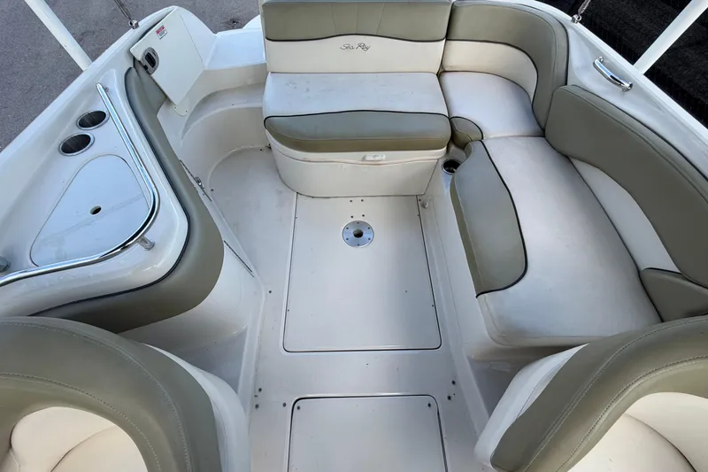 Slide: The Image of 2005 Sea Ray 240 Sundeck interior with spacious seating and cup holders. - 62