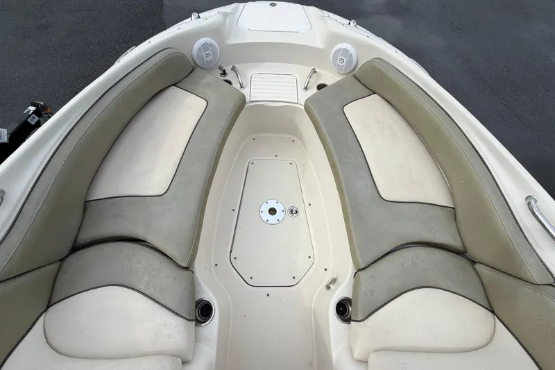 Slide: The Image of 2005 Sea Ray 240 Sundeck boat interior with cushioned seating and storage compartments. - 18
