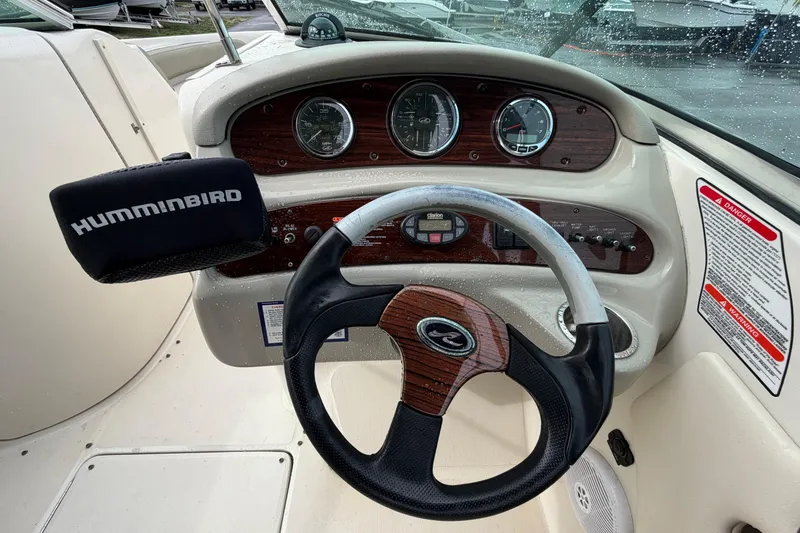 Slide: The Image of Steering wheel and dashboard of a 2005 Sea Ray 240 Sundeck boat with Humminbird device. - 16