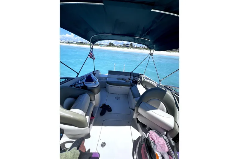 Slide: The Image of 2005 Sea Ray 240 Sundeck boat interior with seating, canopy, and ocean view. - 6