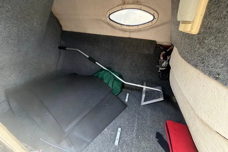 Slide: The Image of Interior cabin of a 2005 Sea Ray 240 Sundeck boat, showing storage space and equipment. - 44