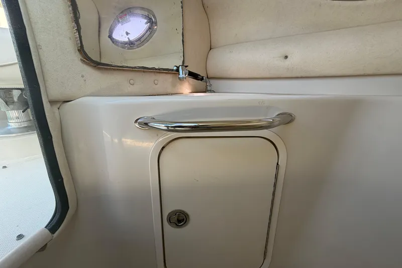 Slide: The Image of Interior of 2005 Sea Ray 240 Sundeck boat with storage compartment and porthole. - 39
