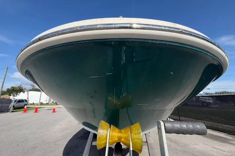 Slide: The Image of 2005 Sea Ray 240 Sundeck boat on trailer, viewed from the front under a clear blue sky. - 10