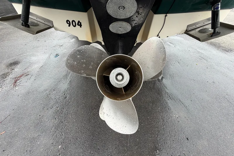 Slide: The Image of Rear view of a 2005 Sea Ray 240 Sundeck boat propeller on wet pavement. - 5