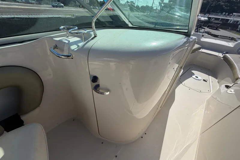 Slide: The Image of 2005 Sea Ray 240 Sundeck interior with seating and windshield view. - 36