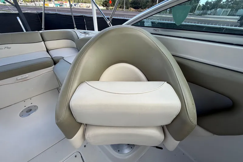 Slide: The Image of 2005 Sea Ray 240 Sundeck interior with cushioned seating and helm chair. - 61