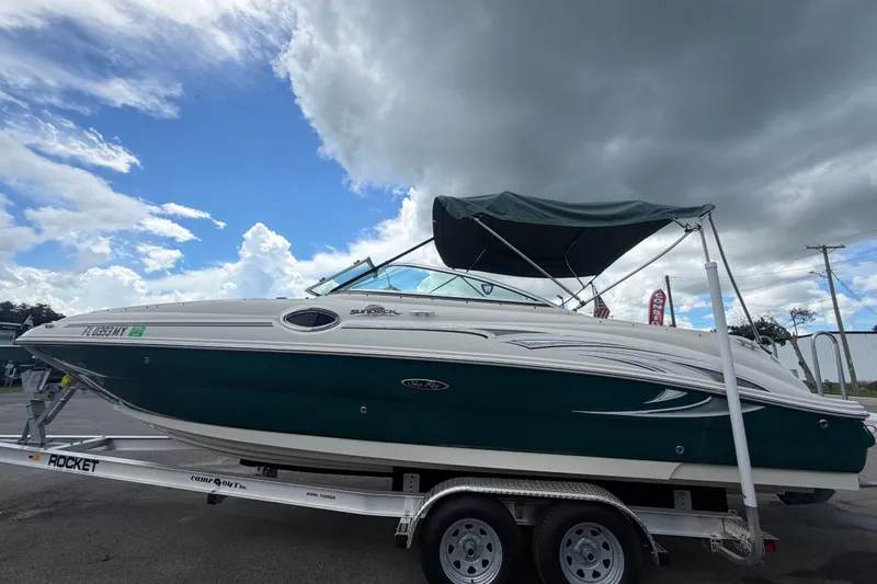 Slide: The Image of 2005 Sea Ray 240 Sundeck boat on trailer under cloudy sky. - 8