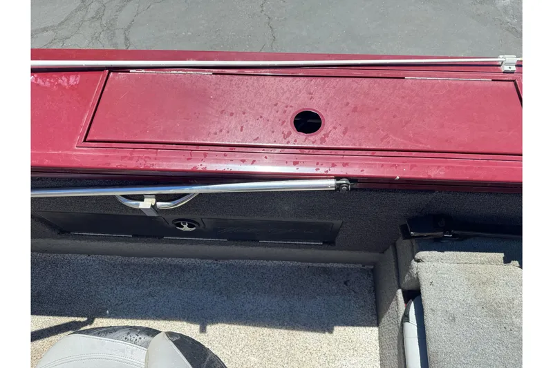 Slide: The Image of 2012 Tracker Targa V-18 Combo boat interior with red storage compartment. - 23
