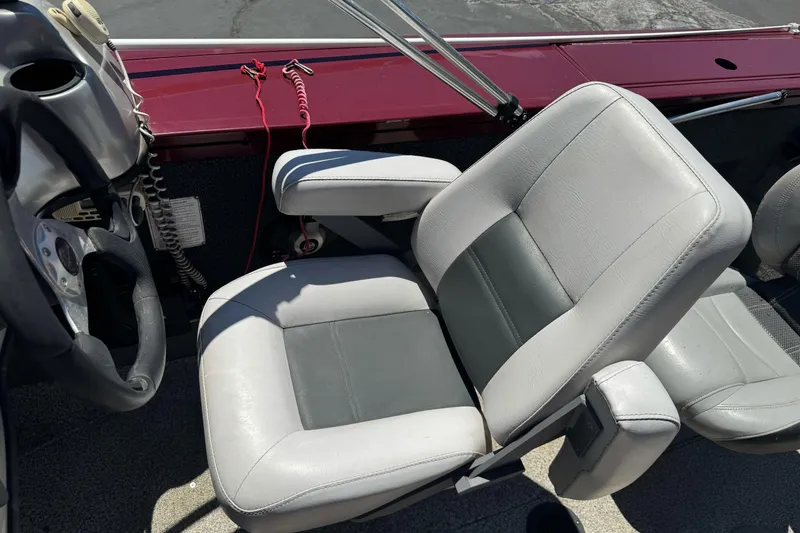 Slide: The Image of 2012 Tracker Targa V-18 Combo boat interior with gray seating and steering wheel. - 16