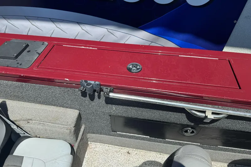 Slide: The Image of 2012 Tracker Targa V-18 Combo boat interior with red storage compartment and seating. - 24