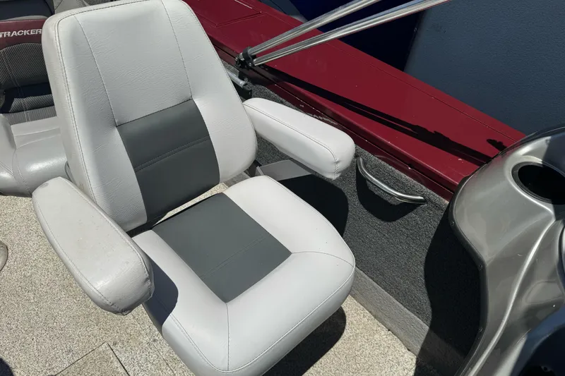 Slide: The Image of 2012 Tracker Targa V-18 Combo boat seat with gray upholstery and armrests. - 15