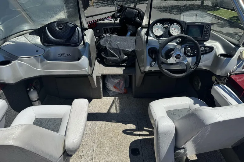 Slide: The Image of 2012 Tracker Targa V-18 Combo boat interior with steering wheel and seating. - 19