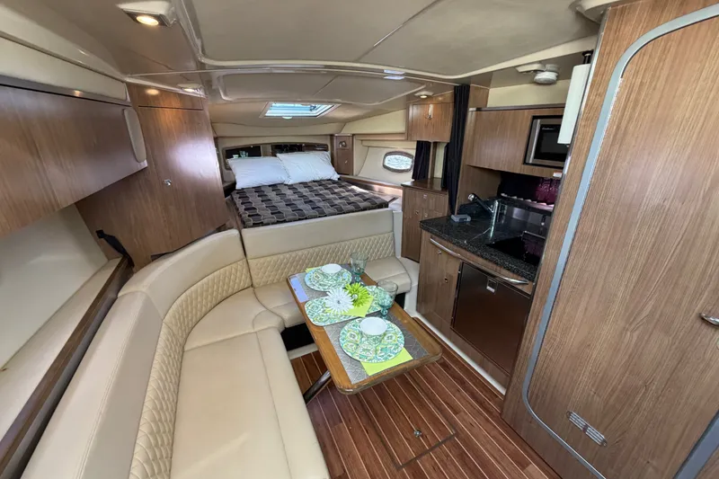 Slide: The Image of Luxurious interior of 2011 Chaparral 310 Signature yacht with dining area and cozy bed. - 18